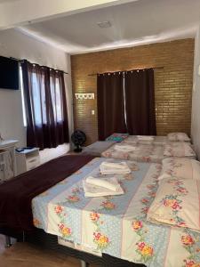 a bedroom with two beds with towels on them at Recanto do Bosque in Majé +46 photos