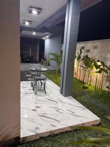 a patio with a table and chairs in a building at MH Villa Deluxe Twin in Pancor