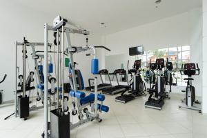 a gym with several treadmills and cardio machines at Loft c Varanda, Piscina e Academia em Itacuruca in Itacuruçá