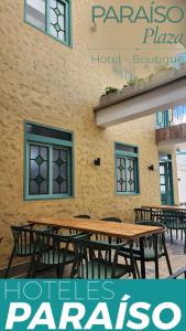 a group of tables and chairs in front of a building at Paraíso Plaza - Hotel Boutique in Aguadas