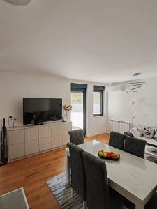 a living room with a table and a couch at Lux Star Belgrade in Belgrade