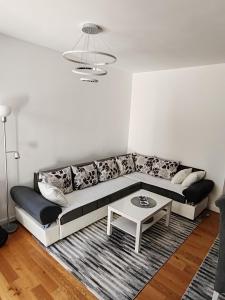 a living room with a couch and a table at Lux Star Belgrade in Belgrade