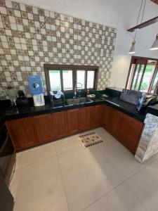 a kitchen with a sink and a counter top at Casa Verde Jade in Areia +37 photos