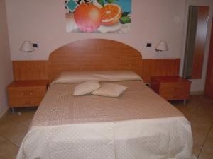 A bed or beds in a room at Residence Hotel La Giara
