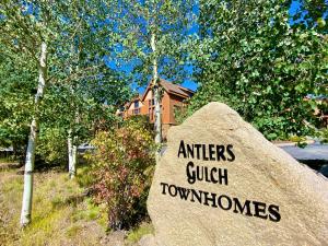 a rock with a sign that reads antlers quick townhomes at Antlers Gulch 501 by SummitCove Lodging in Colorado in Keystone