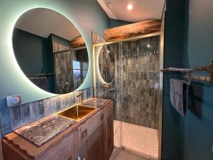 a bathroom with a sink and a mirror at Ferme Ihartzetako in Ascain