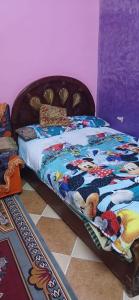 a bed with a colorful quilt on it in a room at Lavande Nubian House in Aswan