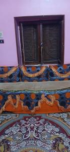 a bed in a room with a window at Lavande Nubian House in Aswan