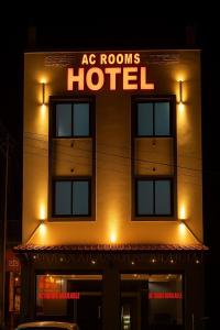 a building with a sign that reads ac rooms hotel at Shree Hanuman Hotel in Rīngas