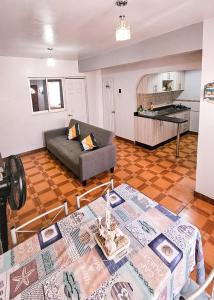 a living room with two tables and a couch at Apart-Hotel Katari in Arica