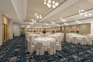 a banquet hall with white tables and chairs at Hilton Arcadia Los Angeles in Arcadia