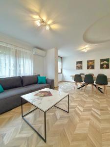 a living room with a couch and a table at Apartment Draganovi 8A in Kazanlŭk