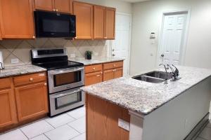 カイルにあるLovely Room 1 Near San Marcosatxのシンクとコンロのあるキッチン トップオーブン