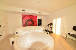 una sala de estar con un sofá blanco y una pintura en Futurcasa Casa rural Spa y cine, en La Felipa