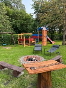 a park with a fire pit and a playground at Las Palmas in Bysławek