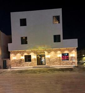 un edificio con luces de noche. en رايز العارض للشقق المخدومة, en Riad