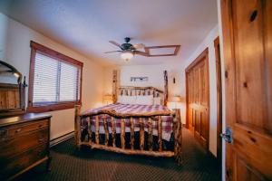 a bedroom with a bed and a ceiling fan at The Loose Moose Lodge #1 At Downtown Grand Lake in Grand Lake