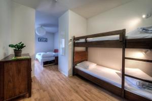 a room with two bunk beds and a desk at Zenitude Hôtel-Résidences l'Acacia Lourdes in Lourdes