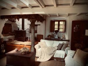 a living room with a white couch and a fireplace at Casa Castro de Crecente in Valdoviño