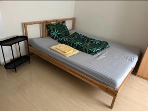 a bed with green pillows on it in a room at Italian Guesthouse in Baden