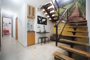 a hallway with a staircase in a home with a kitchen at Casa Borbon in Salento
