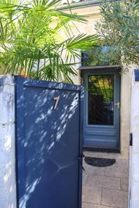 a blue door with the number on it in front of a house at Maison T3 - 2 chambres lits doubles in Lormont