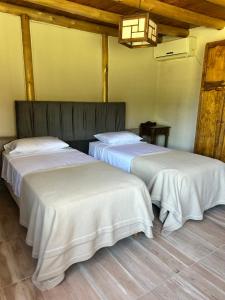 Postel nebo postele na pokoji v ubytování Cabañas del Pasaje