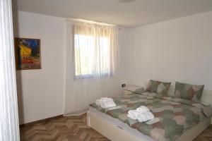 a bedroom with a bed with towels on it at Apartment Draganovi 8A in Kazanlŭk +18 photos