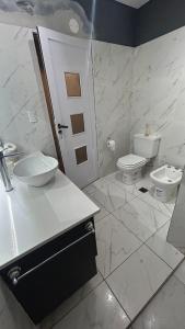 a bathroom with a sink and a toilet at Eliseo Chalet in Yerba Buena