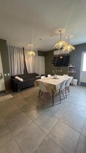 a living room with a table and chairs and a couch at Eliseo Chalet in Yerba Buena