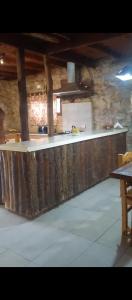 a large kitchen with a counter in a building at Alma de Colibrí in Mar del Plata