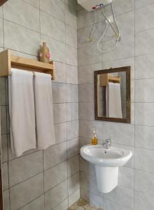 a bathroom with a sink and a mirror at Materuni Home Stay in Uru East