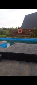 a swimming pool with an orange ring in the water at Alma de Colibrí in Mar del Plata