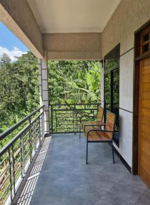 a balcony of a house with a bench on it at Materuni Home Stay in Uru East