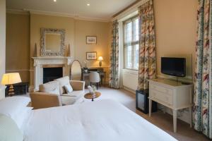 a hotel room with a bed and a tv at Gisborough Hall Hotel in Guisborough