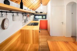 a kitchen with wood countertops and a red refrigerator at Idyllic cottage in beautiful Alps in Zgornje Jezersko