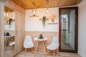 a dining room with white chairs and a table at Airport Connection in Iaşi