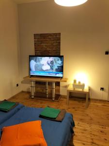 a living room with a large flat screen tv at Szczecin Prawobrzeże Apartament Zajazd in Szczecin