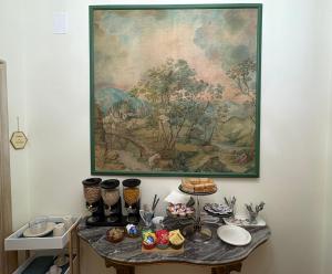 a table with food on it with a painting on the wall at Le Balze Camere in Villa in Perugia +30 photos