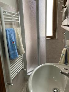 a bathroom with a white sink and a shower at Casa vacanza La Seggiara in San Giovanni Incarico