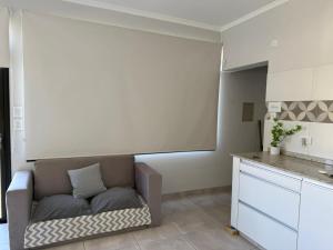 a living room with a couch in a kitchen at Las moras saladillo in Saladillo +9 photos