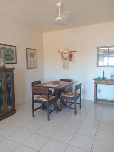 une salle à manger avec une table et deux chaises dans l'établissement Apartamento Capão Novo, à Capão Novo