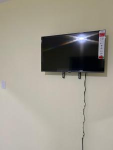 a flat screen tv hanging on a wall at Eastern Breeze in Hainamosa