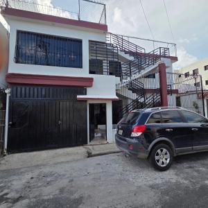 a black car parked in front of a building at Eastern Breeze in Hainamosa