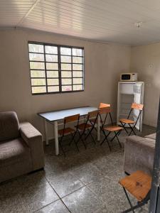 a living room with a table and chairs and a couch at Sítio Bela Vista in Areado
