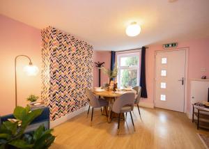 a dining room with a table and chairs at Stylish central location 3 bedroom house in Ely