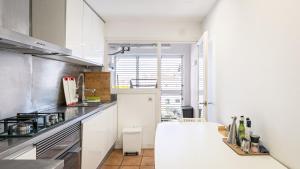 eine Küche mit weißen Schränken und einer Arbeitsplatte in der Unterkunft Apartment Boutique Hort in Cadaqués