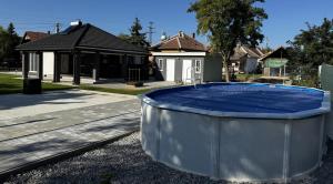 a house with a large tub in front of a house at Silver Chill Apartman in Abádszalók