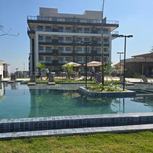 a pool of water in front of a building at SouMais Icaraí, Varanda dos Sonhos in Niterói