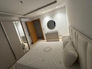 a bedroom with a large white bed with a mirror at Le Relais Résistance Luxury in Sousse